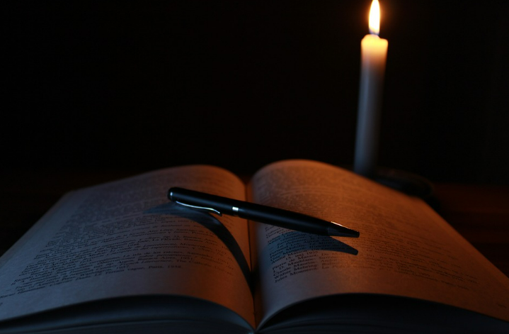 secretive book in candle light
